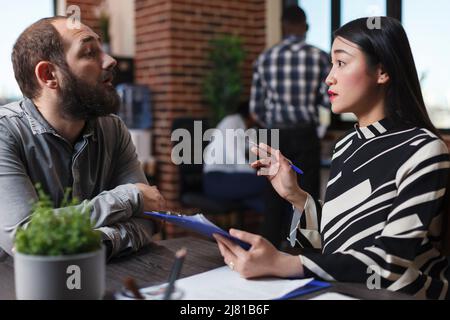 Executive manager interviewing worker applicant recruiting for hr job discussing business offer in startup office. Businesswoman hiring candidate after checking cv resume. Recruitment concept Stock Photo