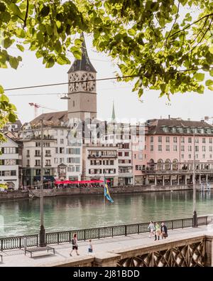 Zurich Switzerland. 7. July 2018 Scenic view of historic Zurich city center with famous St.Peter's church and river Limmat at Lake Zurich, Stock Photo