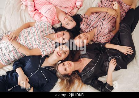 Beautiful ladies enjoying party and showing their tongues Stock Photo