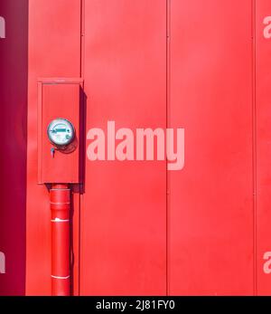 Water meter on red color wall for measurement of water flow. Water environmental conservation and water resource management concept-April 11,2022-Vanc Stock Photo