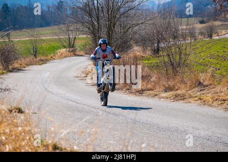 Prague, Czech Republic - March 13, 2022: Unknown rider of motocross on rural road near Prague Stock Photo