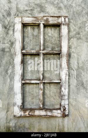 Old wooden frame from a window on a plastered wall, close-up Stock Photo