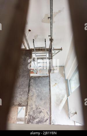 Scaffolding on the construction site in house when building a house for painting and spatula work Stock Photo