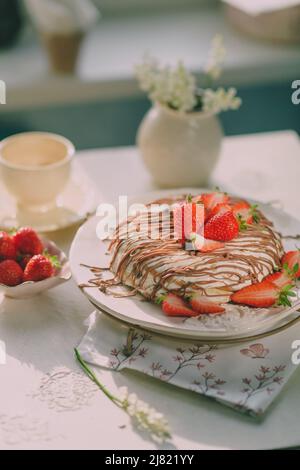 birthday cake with cream, strawberries and chocolate Stock Photo