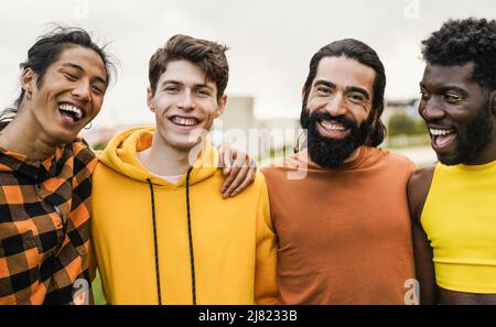 Multiethnic diverse male friends having fun together outdoor - Focus on bearded man Stock Photo