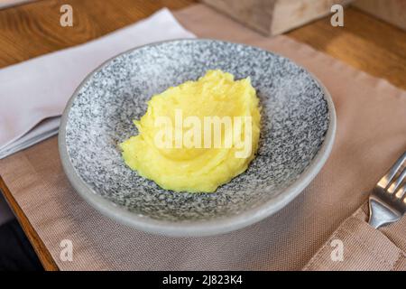 mashed potatoes in a plate on the table in a restaurant Stock Photo