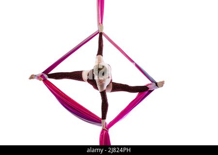 Portrait of young woman, air gymnast training, performing isolated over white studio background. Aerial silk exercises Stock Photo