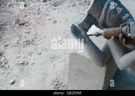 Breathing Life Into Stone, Stone Artisans or Stone Masons Who Tirelessly Toil To Create Masterpieces From Black Granite Stone. Odisha, Balasore, India Stock Photo
