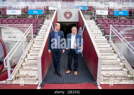 The Duke of Cambridge walks down the tunnel at Tynecastle Park with Billy Watson, chief executive of the charity SAMH, during a visit to Heart of Midlothian Football Club, Edinburgh, to see a programme called 'The Changing Room' launched by SAMH (Scottish Association for Mental Health) in 2018 and is now delivered in football clubs across Scotland. Picture date: Thursday May 12, 2022. Stock Photo