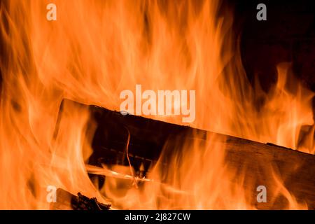Crest of flame on burning wood in fireplace Stock Photo