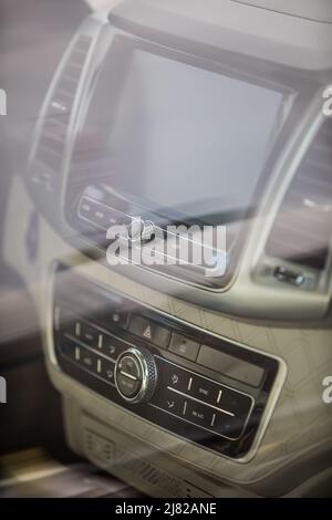 Close-up shot of a car's multimedia and navigation display on the dashboard. Stock Photo
