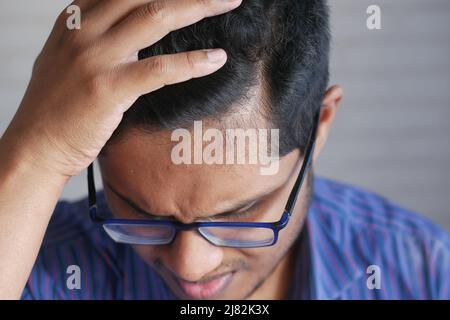 hair loss concept with man checking his hair  Stock Photo