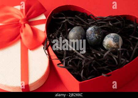 Naturally colored eggs in a red gift box. A Easter Eggs as a symbol of Easter, spring, April, fertility. Greeting card template. Stock Photo