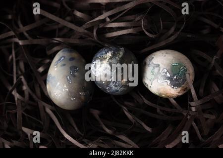 Marble blue Easter eggs ion a black background. Happy Easter holiday, top view, flat lay . Horizontal photo. Hibiscus eggs, naturally colored. Stock Photo