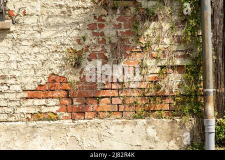 House facade vintage crumbling plaster and brick wall Stock Photo