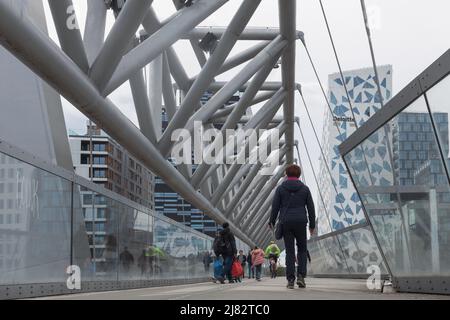 Oslo, Norway. May 02, 2022: Pedestrian bridge in Oslo, Norway. View of urban architecture. A group of pedestrians Stock Photo