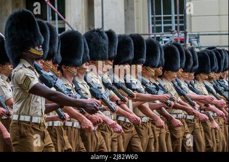 London, UK. 12th May, 2022. Guardsmen drill, at Wellington Barracks, as a practice for Trooping the Colour. They wear service dress but also the bearskins of their full dress uniforms - Preparations for the celebration of the Platinum Jubilee of HM The Queen Elizabeth. Credit: Guy Bell/Alamy Live News Stock Photo