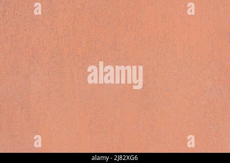 Grunged Plaster Wall painted in Terracotta Color. Stock Photo