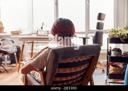 Young stylish man resting at his flat opposite the window Stock Photo