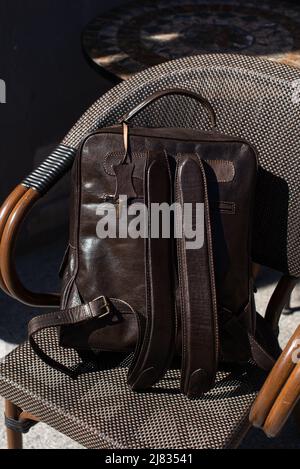 Brown leather backpack on the stylish chair Stock Photo