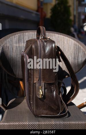 Brown leather backpack on the stylish chair Stock Photo