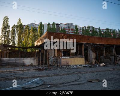 Kharkiv, Kharkov, Ukraine - 05.07.2022: burnt destroyed cafe shop metal structure construction on street in city after bombing background of civilian Stock Photo