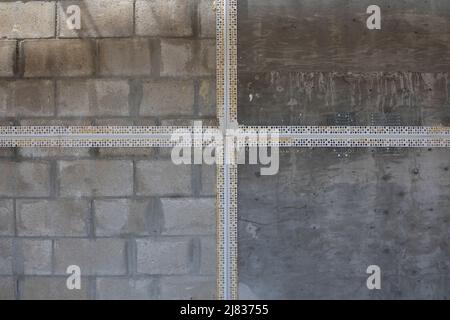 exterior wall of an affordable housing complex before stucco installation on different surfaces. The after image is also available. Corner beading Stock Photo