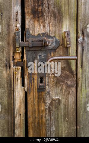 close-up of beautiful nostalgic locks on a barn door made of rustic wood Stock Photo