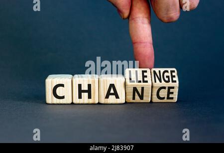 Chance or challenge symbol. Businessman turns wooden cubes and changes the concept word challenge to chance. Beautiful grey table grey background. Bus Stock Photo