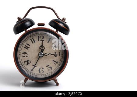 Old retro alarm clock in brown on white background Stock Photo