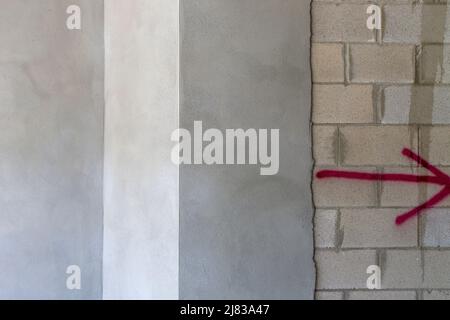 partially finished stucco on a wall with cinder concrete blocks underneath Stock Photo