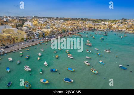 Aerial panoramic view of Marsaxlokk - small, traditional fishing village in the South Eastern Region of Malta with many colorful fisherman boats Stock Photo