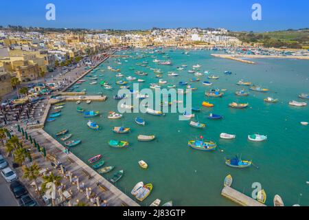 Aerial panoramic view of Marsaxlokk - small, traditional fishing village in the South Eastern Region of Malta with many colorful fisherman boats Stock Photo