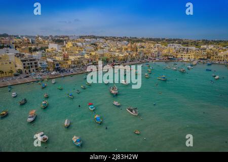 Aerial panoramic view of Marsaxlokk - small, traditional fishing village in the South Eastern Region of Malta with many colorful fisherman boats Stock Photo