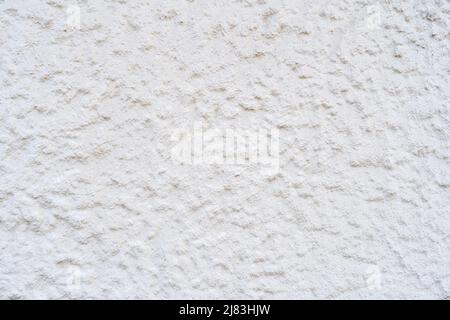 Rough plaster of a white house wall with a number of large and small structure points Stock Photo