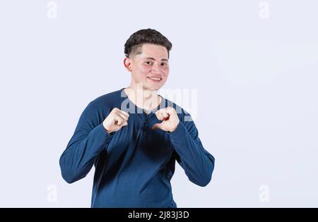 Smiling man pointing at himself, a person who smiles pointing at himself, It's me, portrait of a man pointing at himself, Happy guy smiling pointing Stock Photo