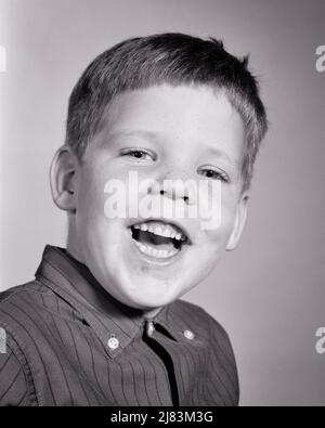 1960s PORTRAIT OF LAUGHING BOY LOOKING AT CAMERA WEARING STRIPED SHIRT WITH BUTTON DOWN COLLAR - j11139 HAR001 HARS JOY LIFESTYLE STRIPED INSPIRATION MALES CONFIDENCE EXPRESSIONS B&W EYE CONTACT HEAD AND SHOULDERS CHEERFUL DISCOVERY EXCITEMENT SMILES CONCEPTUAL JOYFUL STYLISH JUVENILES BLACK AND WHITE CAUCASIAN ETHNICITY HAR001 OLD FASHIONED Stock Photo