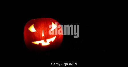 Glowing pumpkins at night, pumpkin face, carved pumpkins, grimace, halloween, dark background Stock Photo