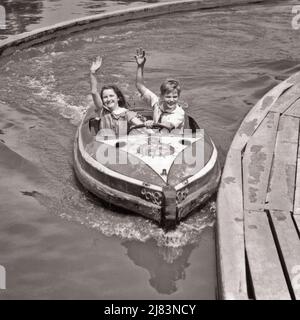 1930s BOY AND GIRL RIDING IN AMUSEMENT PARK RIDE OF A BOAT IN A CHANNEL OF WATER - j7919 HAR001 HARS PLEASED JOY LIFESTYLE FEMALES BROTHERS BOATS COPY SPACE FRIENDSHIP HALF-LENGTH PERSONS MALES CARNIVAL ENTERTAINMENT SIBLINGS GESTURING SISTERS TRANSPORTATION B&W EYE CONTACT FREEDOM AMUSEMENT HAPPINESS CHEERFUL HIGH ANGLE ADVENTURE LEISURE AND EXCITEMENT RECREATION PRIDE GESTURES K SIBLING SMILES FRIENDLY JOYFUL MIDWAY CHANNEL RIDES TOGETHERNESS AMUSEMENT PARK BLACK AND WHITE CAUCASIAN ETHNICITY HAR001 OLD FASHIONED THEME PARK Stock Photo