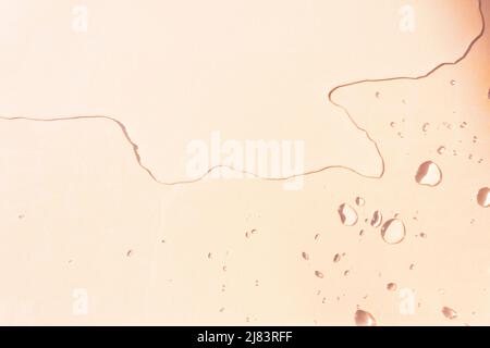 Top view of spilled water on the table with sunlit water drops. Remnant of water drops with varied sizes and shapes. Copy space. Stock Photo