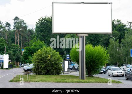 Big billboard in the middle of the street in the city. Place for inscription, isolate. Stock Photo