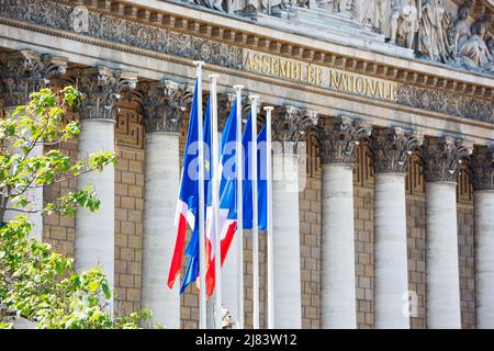 National Flags of France and EU waving in the wind against historical building in Paris Stock Photo