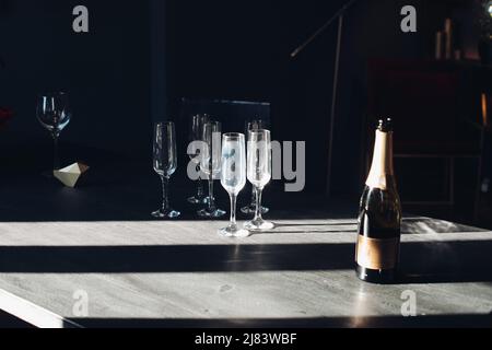 Flutes of champagne on the table. Two wineglasses in sunlight. Stock Photo