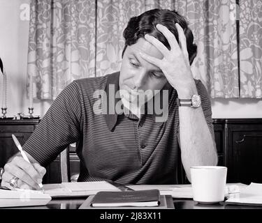 1970s MAN SITTING AT DINING TABLE HOLDING HEAD WITH LEFT HAND WRITING WITH PEN IN RIGHT HAND GOING OVER CALENDAR BILLS PLANNING - s20340 HAR001 HARS PAYING B&W SADNESS HEAD AND SHOULDERS REFLECTIVE THINK CHECKBOOK REFLECTING RIGHT PONDER PONDERING CONSIDER LOST IN THOUGHT CONCEPTUAL HOMEOWNER CONTEMPLATIVE MEDITATE LEFT MEDITATIVE MID-ADULT MID-ADULT MAN YOUNG ADULT MAN BLACK AND WHITE CAUCASIAN ETHNICITY CONSIDERING HAR001 OLD FASHIONED Stock Photo