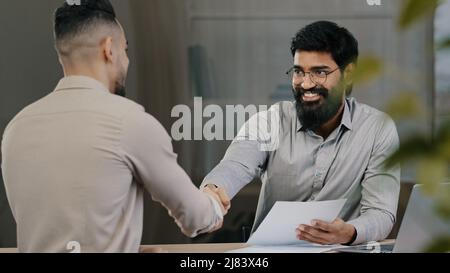 Male arab businessman man financial consultant analyst lawyer consult hispanic client customer explain project document contract at business meeting Stock Photo