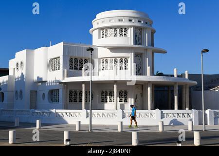 Pedestrian walking in front of a restored Art Deco building in Progreso, a port city on Mexico's Yucatán Peninsula, Mexico Stock Photo