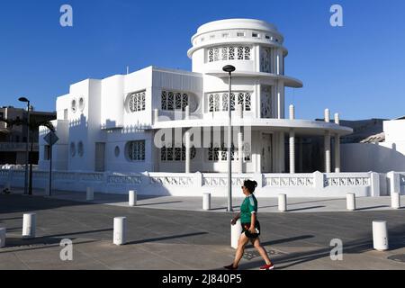 Pedestrian walking in front of a restored Art Deco building in Progreso, a port city on Mexico's Yucatán Peninsula, Mexico Stock Photo