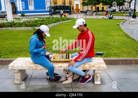 A Young Couple Playing Chess In The Plaza De Armas, Trujillo, La Libertad Region, Peru. Stock Photo
