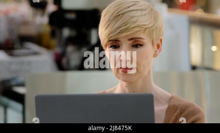Portrait focused professional middle aged adult business woman worker 40s manager freelancer client user laptop working typing chatting consultation Stock Photo
