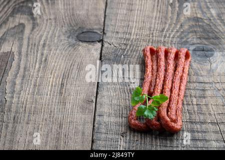 Dry cured  Kabanos sausage on wooden background Stock Photo